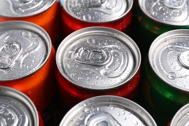 Photo of Energy drinks in wet cans, closeup. Functional beverage