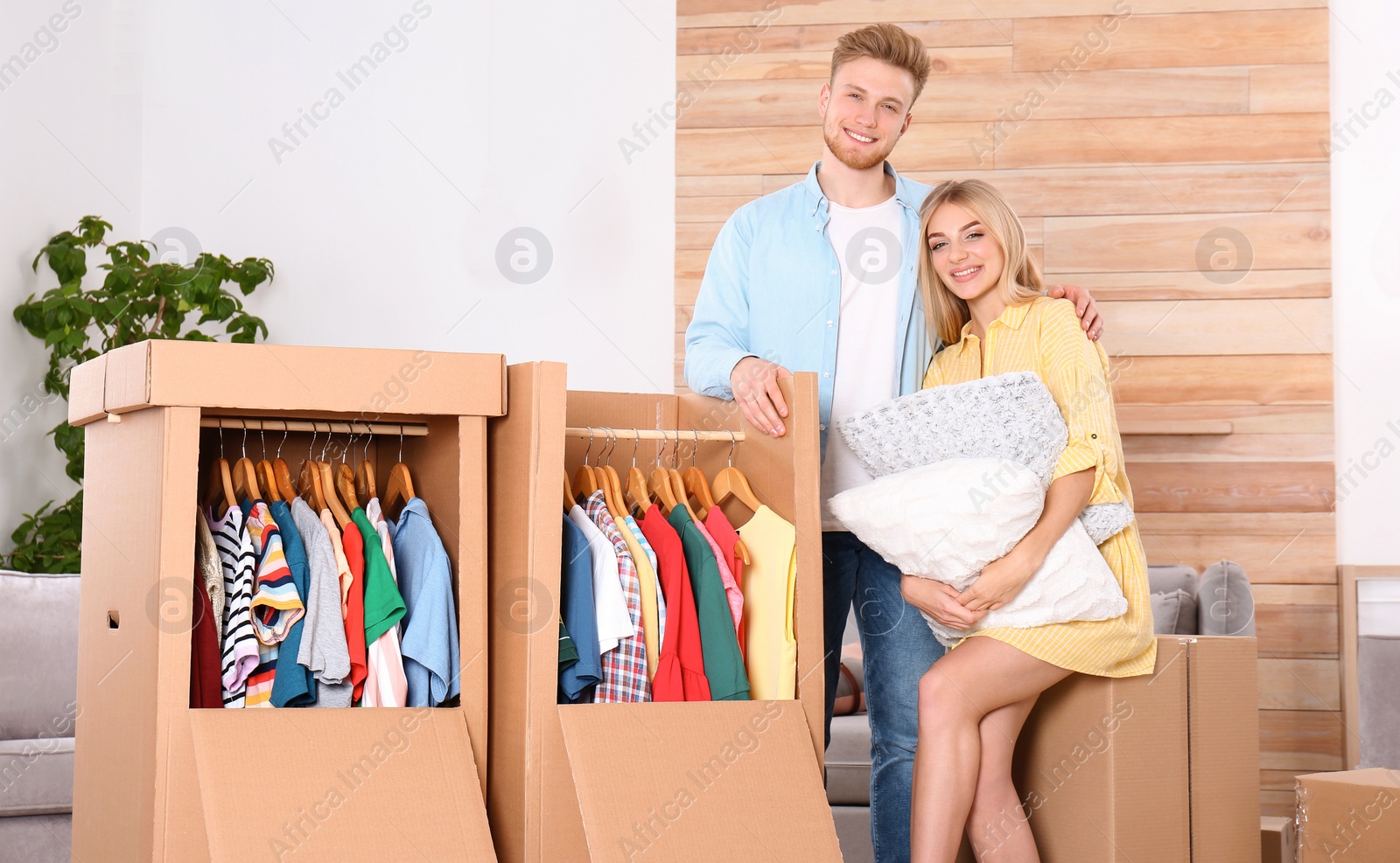 Photo of Young couple near wardrobe boxes at home