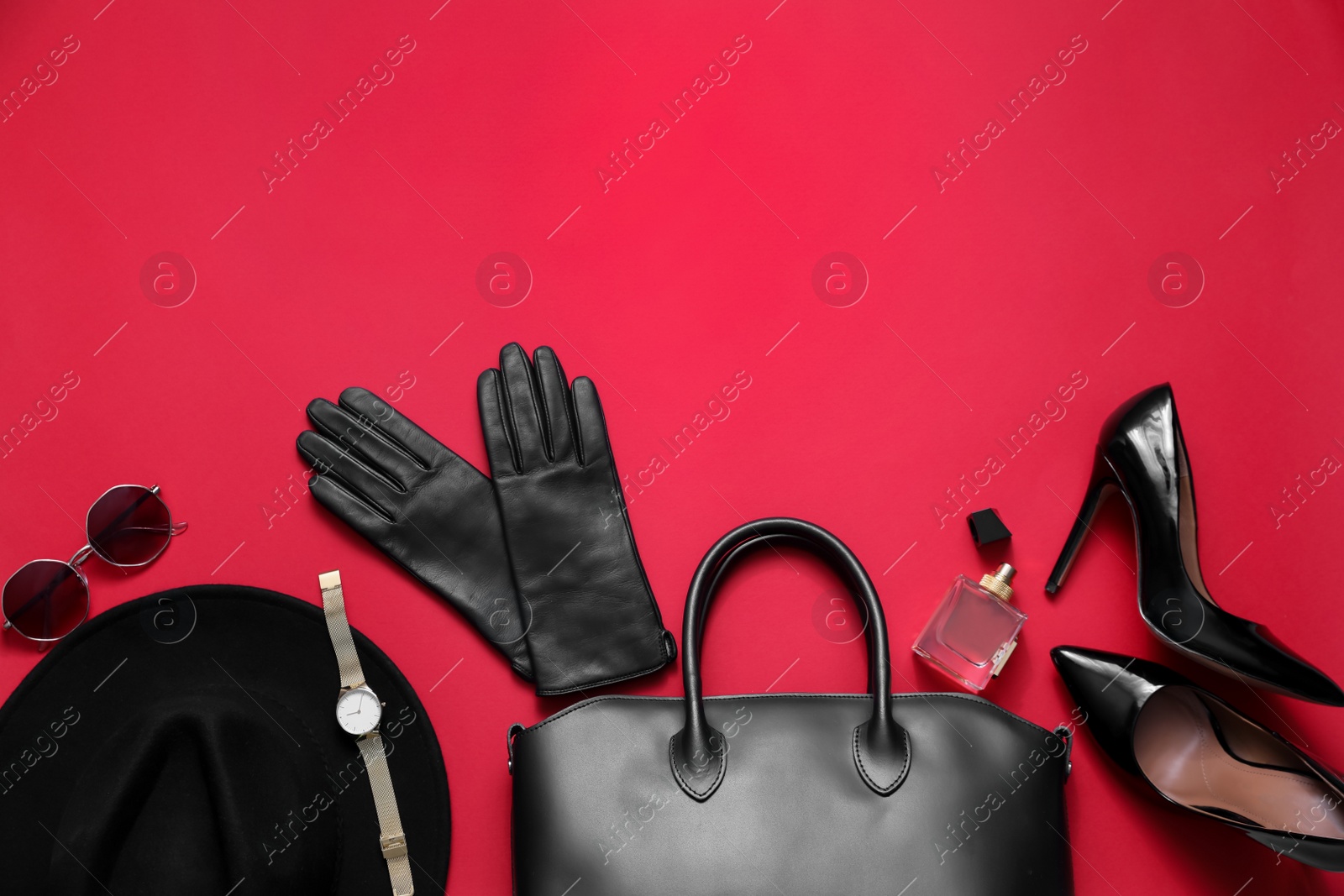 Photo of Flat lay composition with stylish black leather gloves, shoes and accessories on red background. Space for text