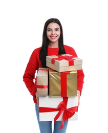 Happy young woman holding Christmas gifts on white background