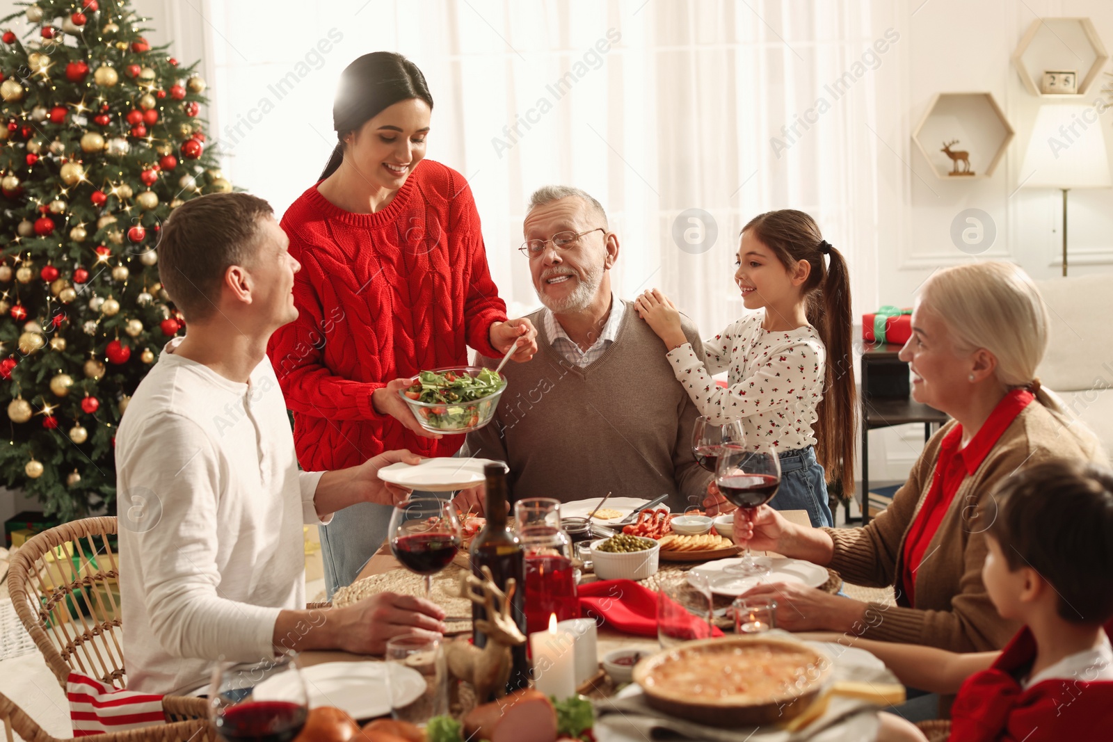 Photo of Happy family enjoying festive dinner at home. Christmas celebration