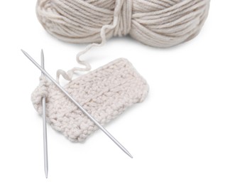 Photo of Soft woolen yarn, knitting and metal needles on white background