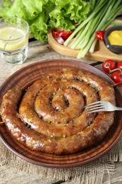 Tasty homemade sausages served on wooden table, closeup