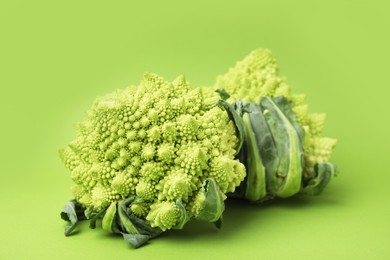 Photo of Fresh raw Romanesco broccoli on green background, closeup