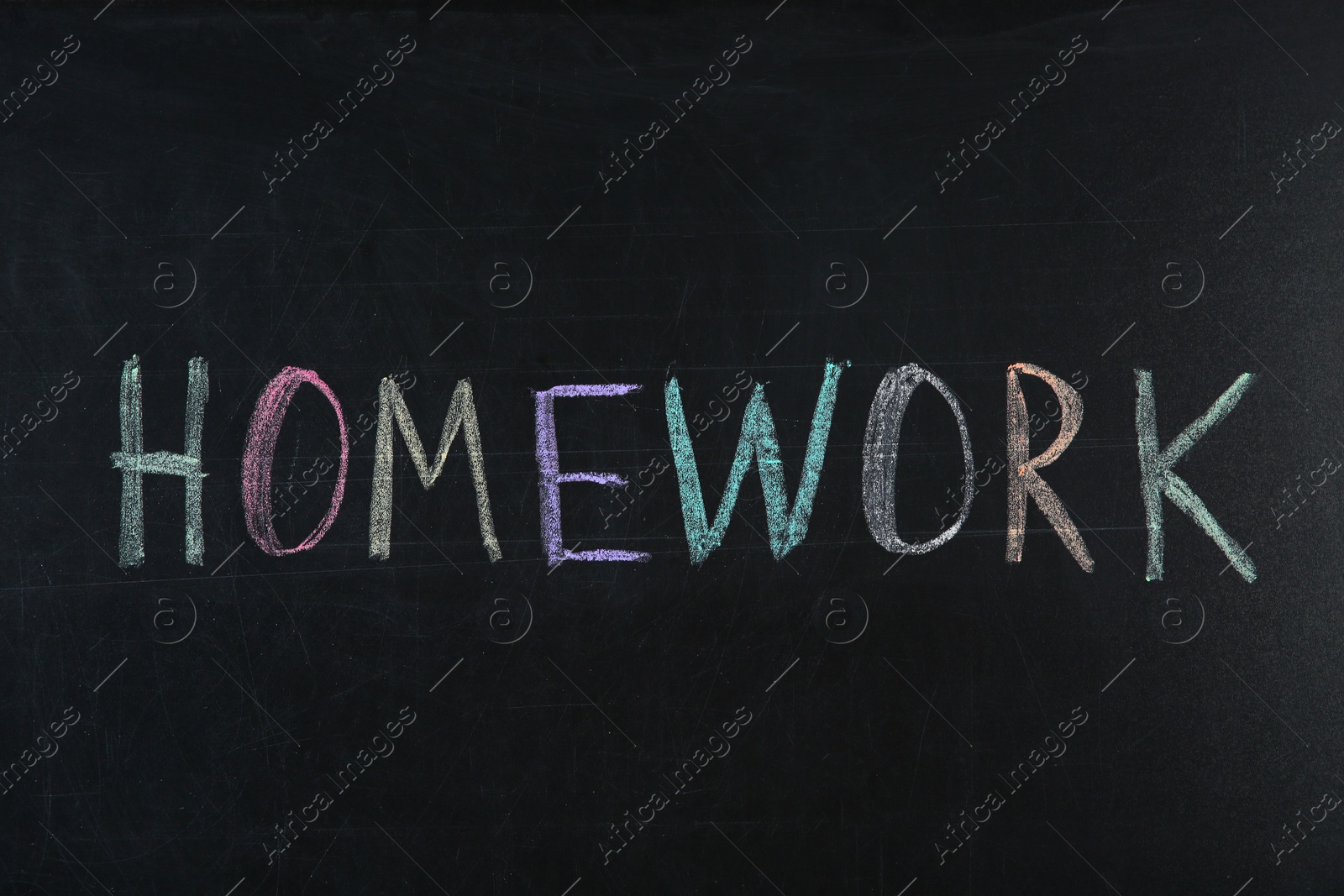 Photo of Word HOMEWORK written with chalk on blackboard