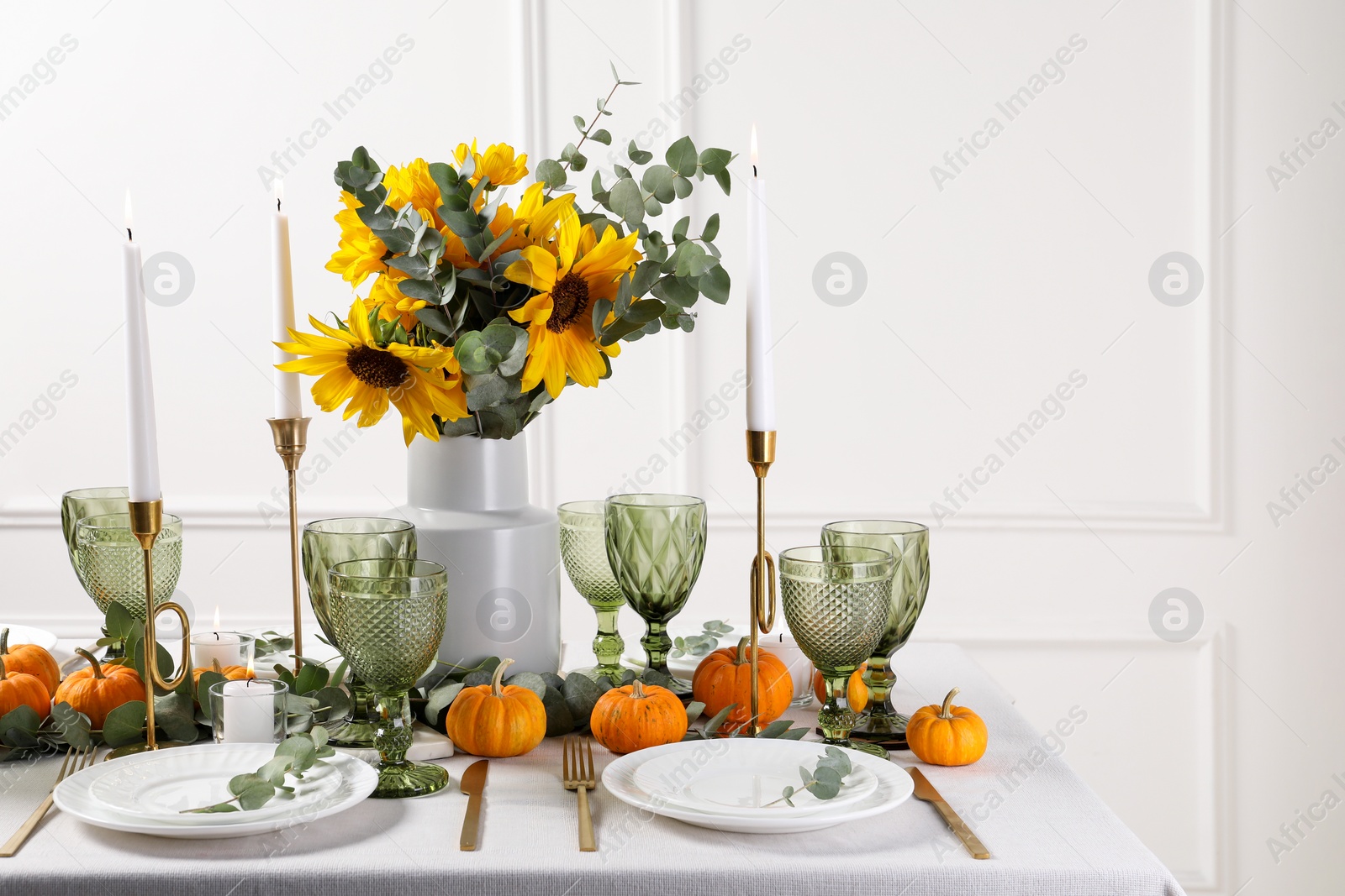 Photo of Beautiful autumn table setting with bouquet indoors. Plates, cutlery, glasses and floral decor