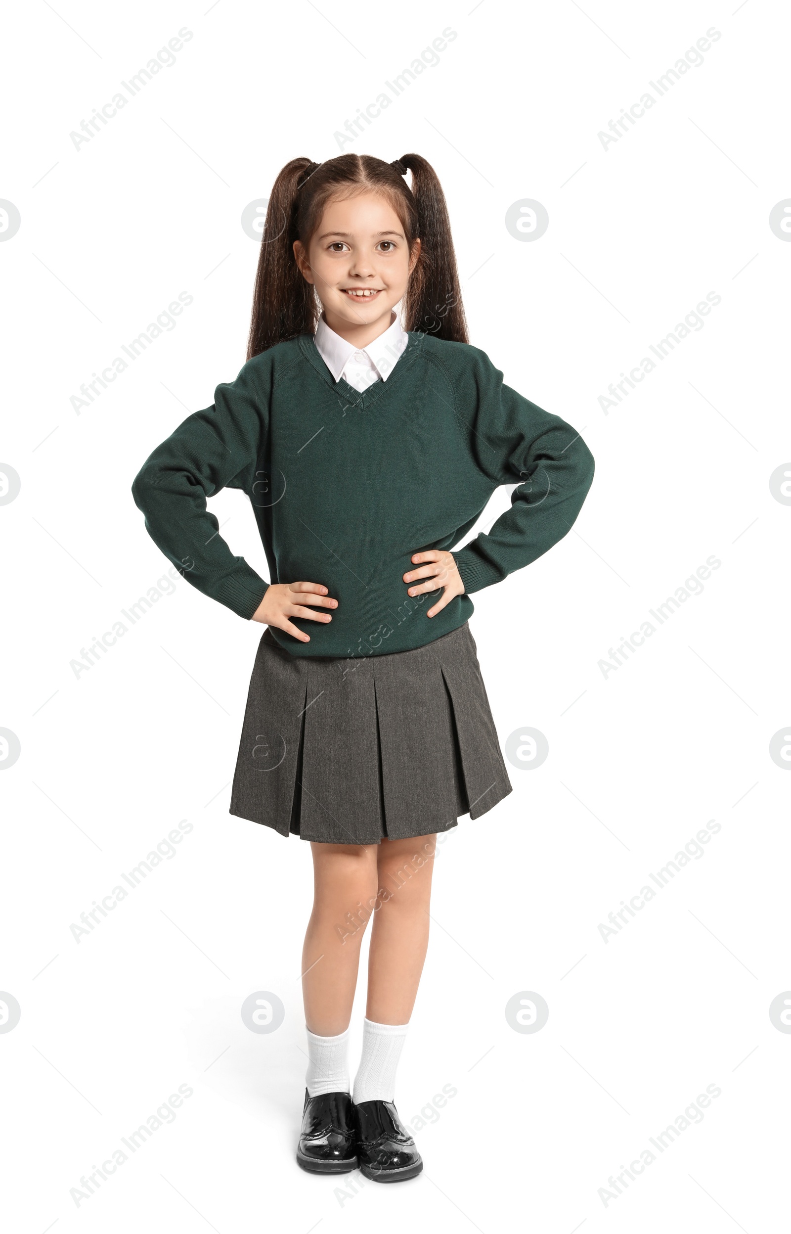 Photo of Little girl in stylish school uniform on white background