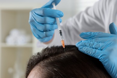 Photo of Trichologist giving injection to patient in clinic, closeup