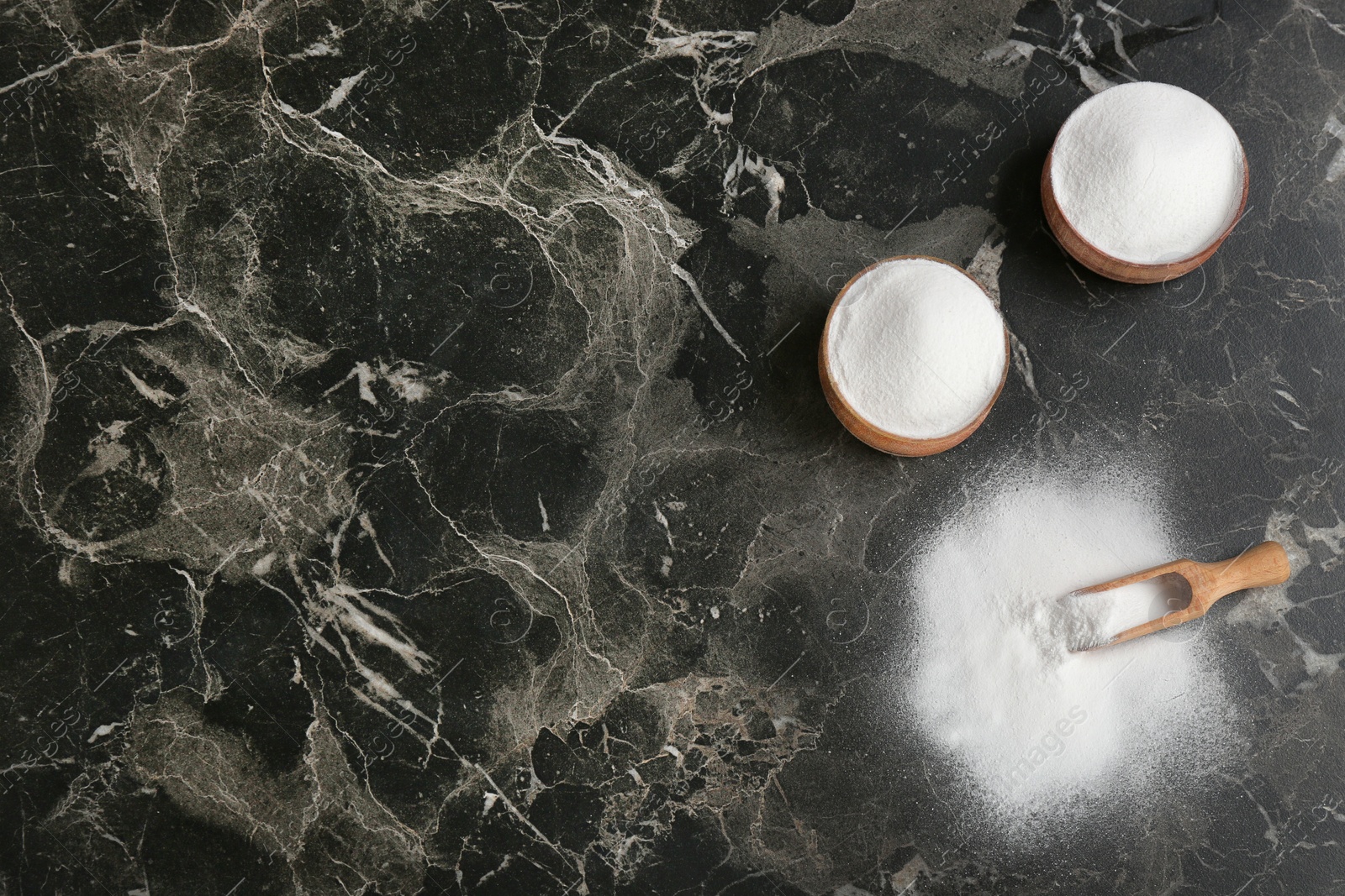 Photo of Flat lay composition with bowls of baking soda and space for text on table