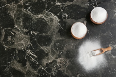 Photo of Flat lay composition with bowls of baking soda and space for text on table