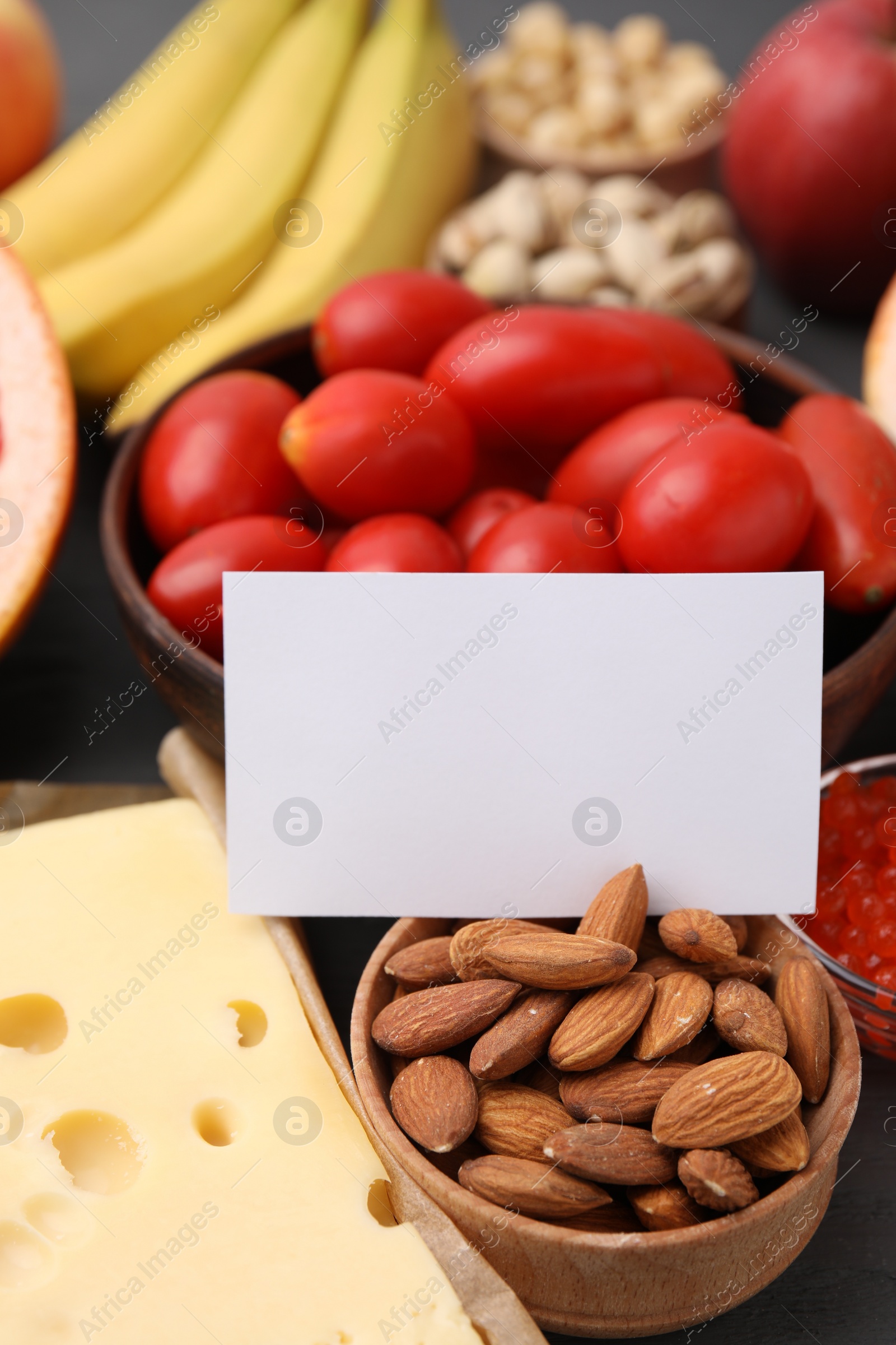 Photo of Many different products and blank card on table, closeup with space for text. Natural sources of serotonin