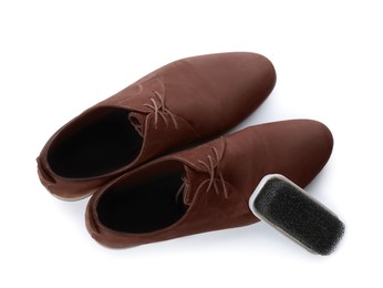 Photo of Stylish footwear and brush on white background, top view. Shoe care accessory