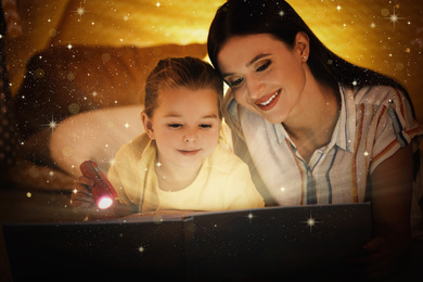 Image of Mother with little child reading magic book at home