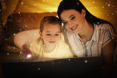 Mother with little child reading magic book at home