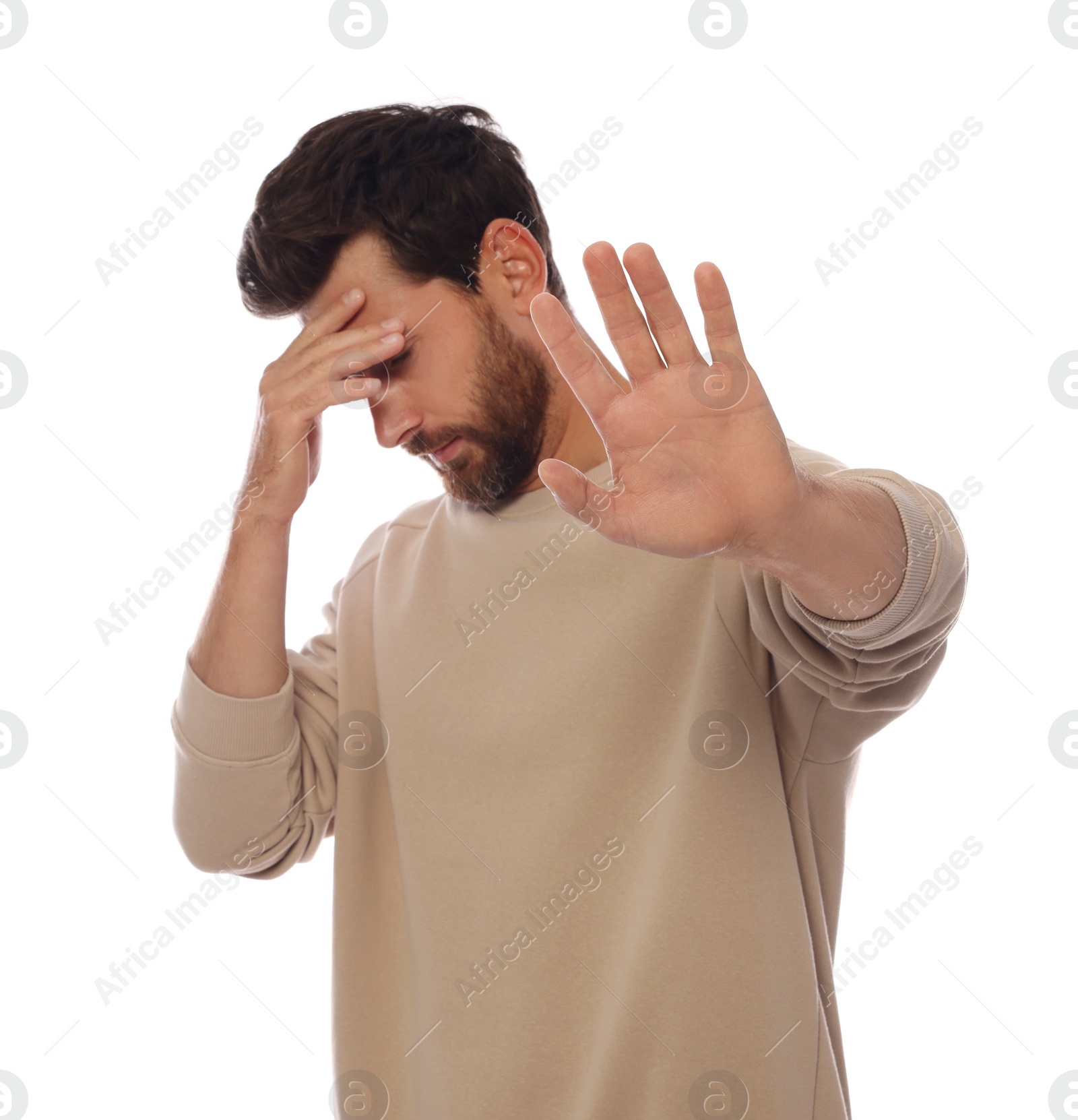 Photo of Embarrassed man covering face with hand on white background