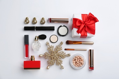 Photo of Flat lay composition with decorative cosmetic products on light background. Winter care