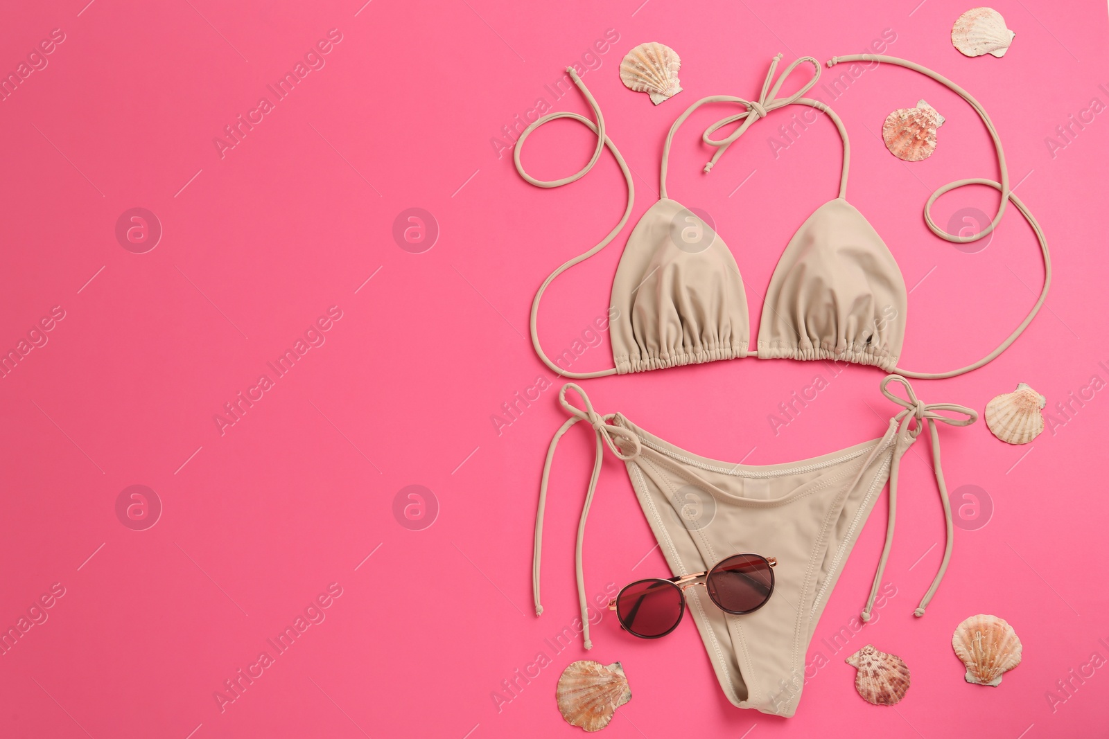 Photo of Flat lay composition with stylish bikini on pink background. Space for text