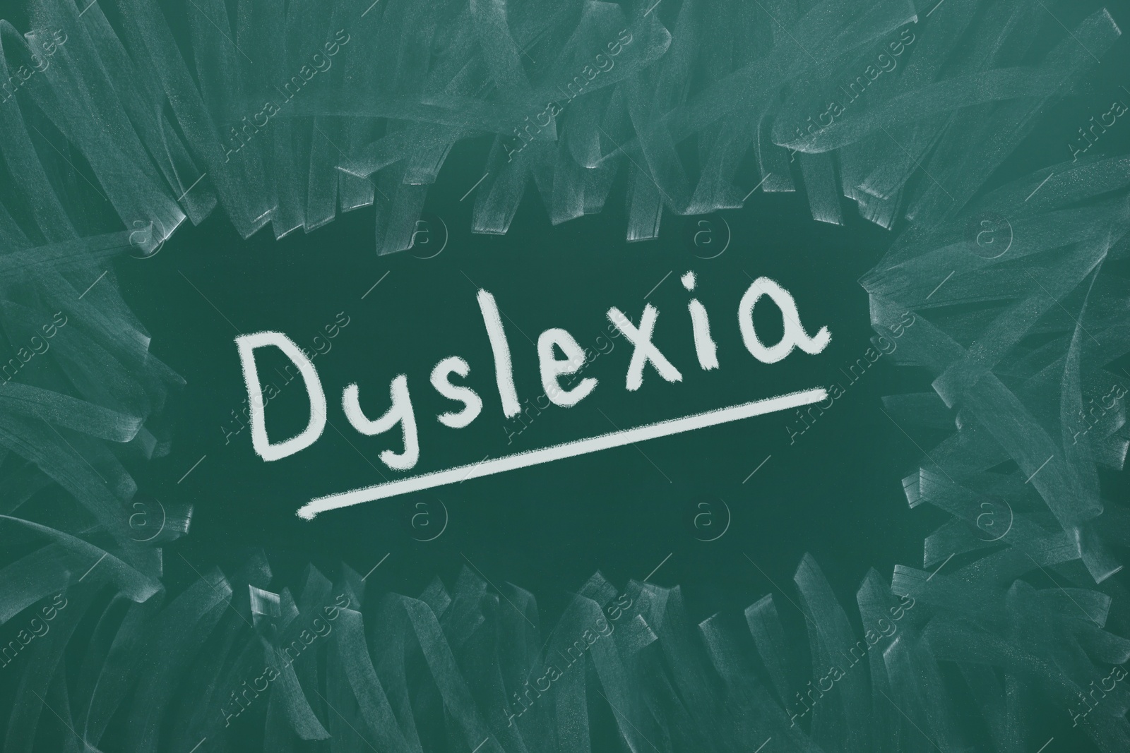 Illustration of Word Dyslexia written on dirty green chalkboard