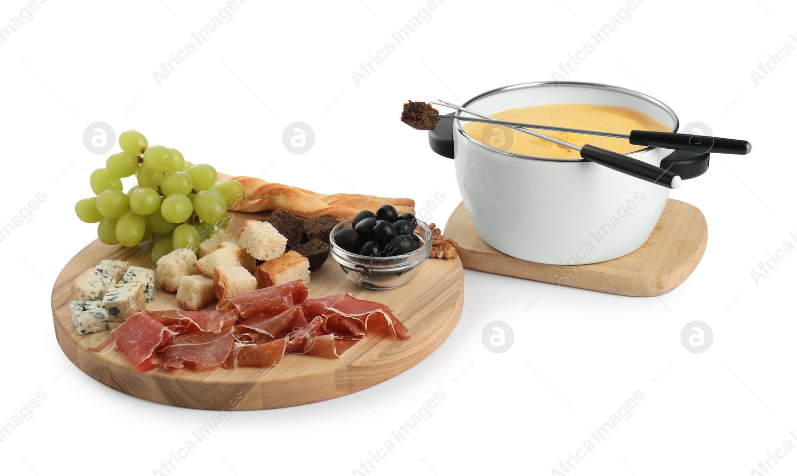 Photo of Fondue with tasty melted cheese, forks and different snacks isolated on white