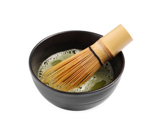 Cup of matcha tea and bamboo whisk isolated on white