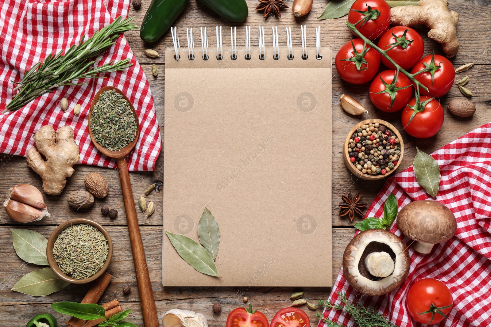 Photo of Open recipe book and different ingredients on wooden table, flat lay. Space for text