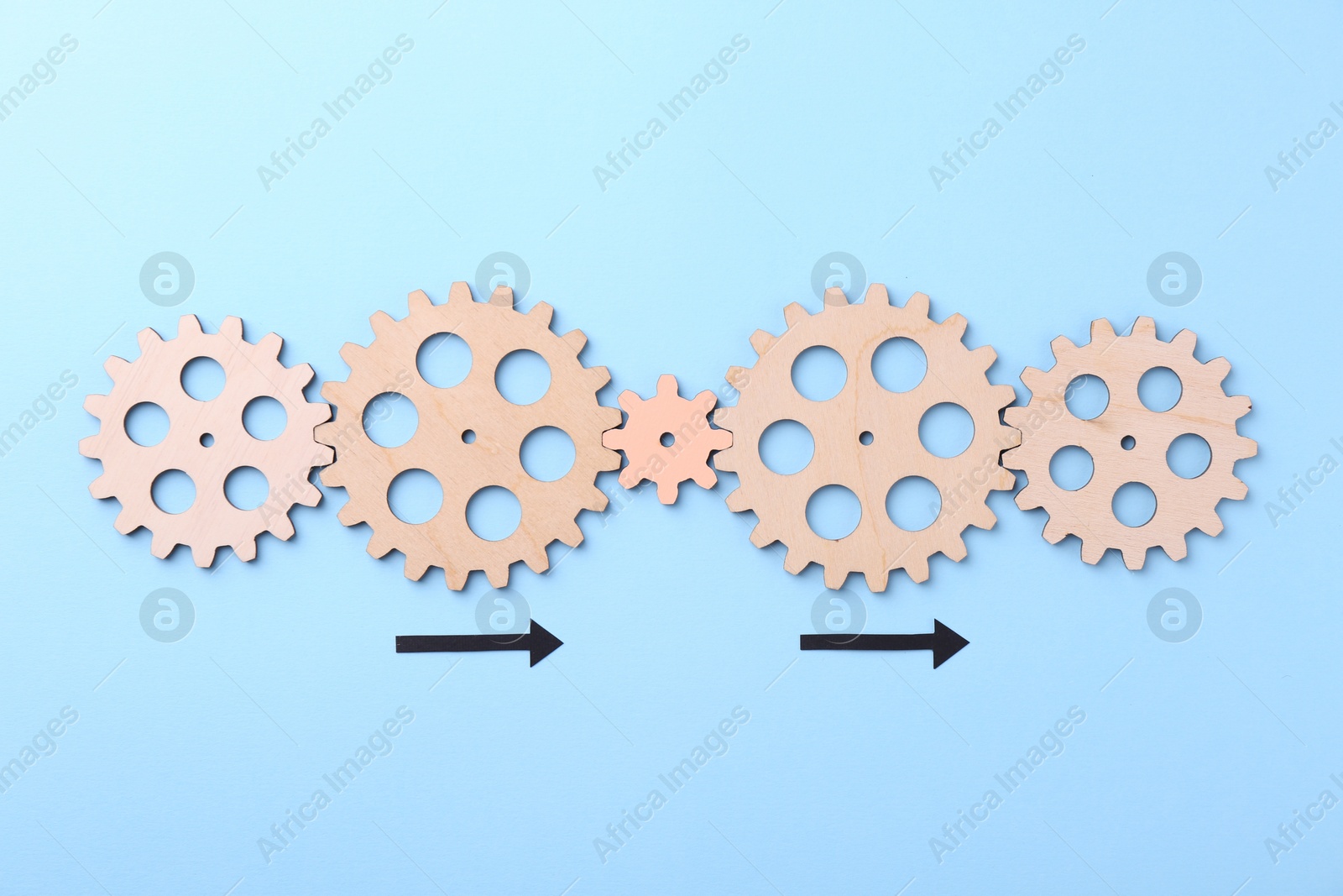 Photo of Business process organization and optimization. Scheme with wooden figures and arrows on light blue background, top view