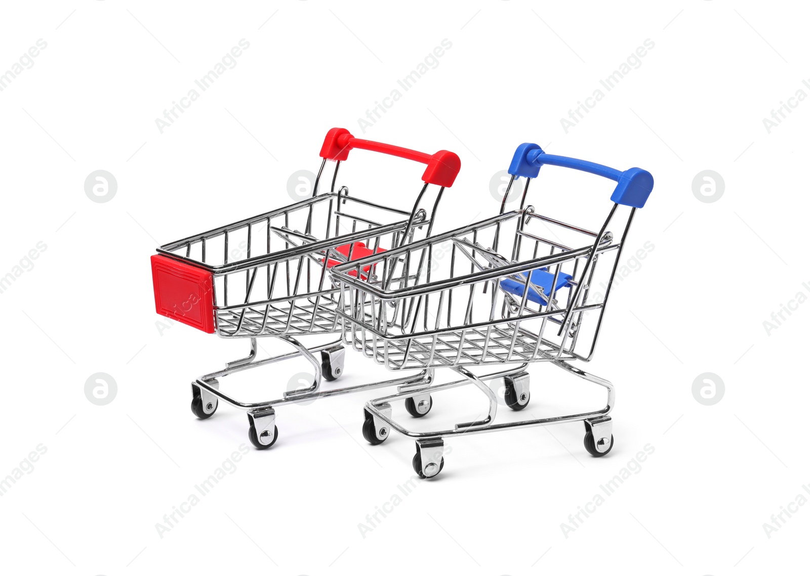 Photo of Empty mini metal shopping carts on white background