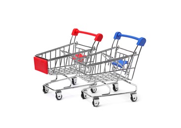 Photo of Empty mini metal shopping carts on white background