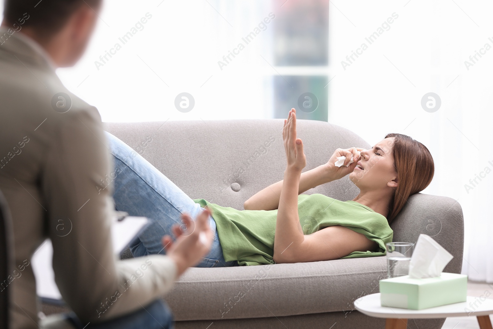 Photo of Psychotherapist working with woman in light office