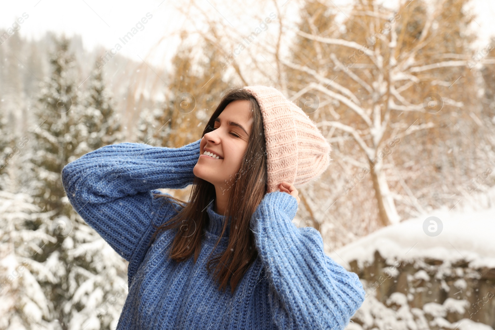 Photo of Pretty woman in warm sweater outdoors on winter day