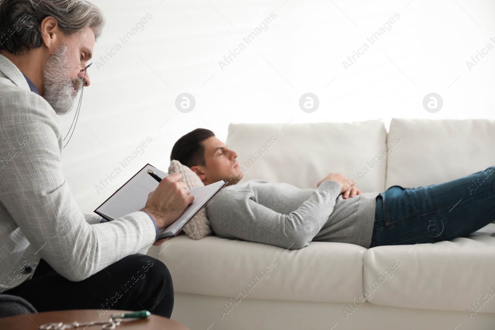 Photo of Psychotherapist and patient in office. Hypnotherapy session