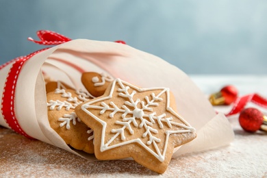 Photo of Tasty decorated Christmas cookies on wooden board, closeup