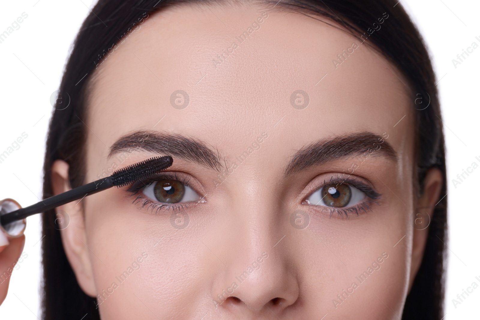 Photo of Beautiful young woman applying mascara on white background, closeup