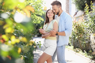 Photo of Lovely young couple dancing together in park on sunny day