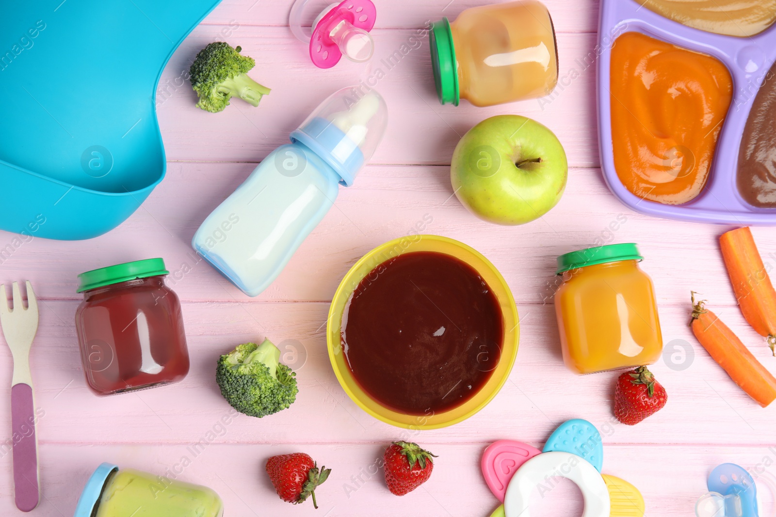 Photo of Flat lay composition with healthy baby food, ingredients and accessories on pink wooden table