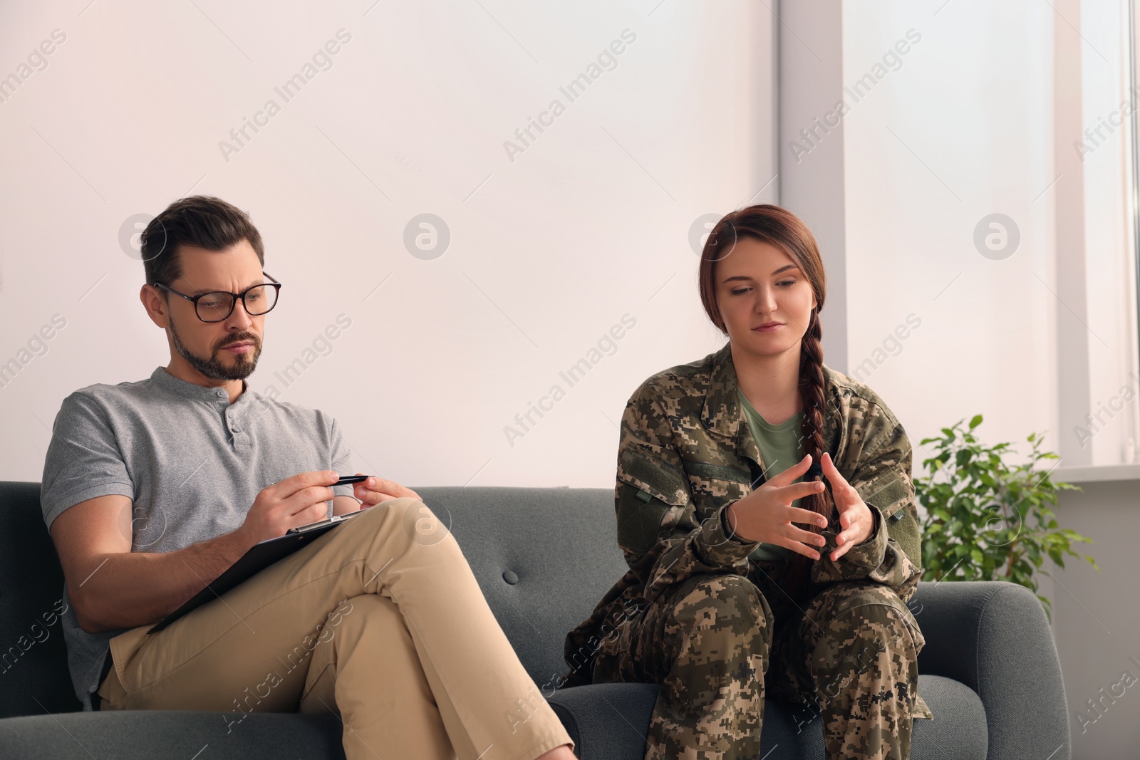 Photo of Psychologist working with female military officer in office