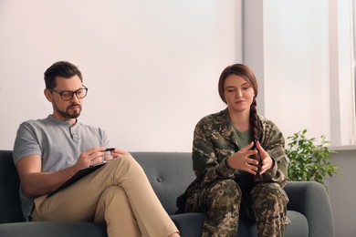 Photo of Psychologist working with female military officer in office