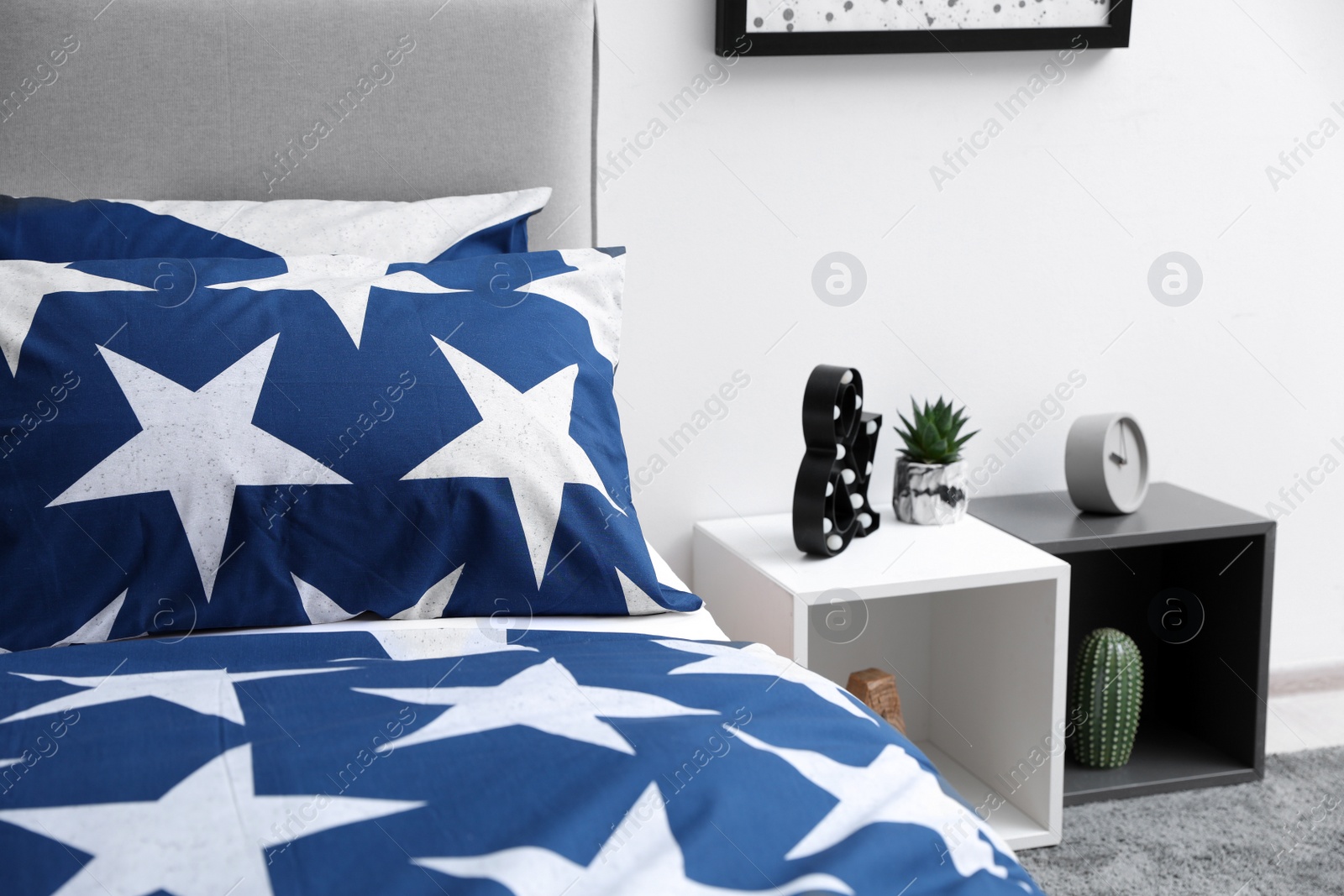 Photo of Bed with stylish linens in children's room