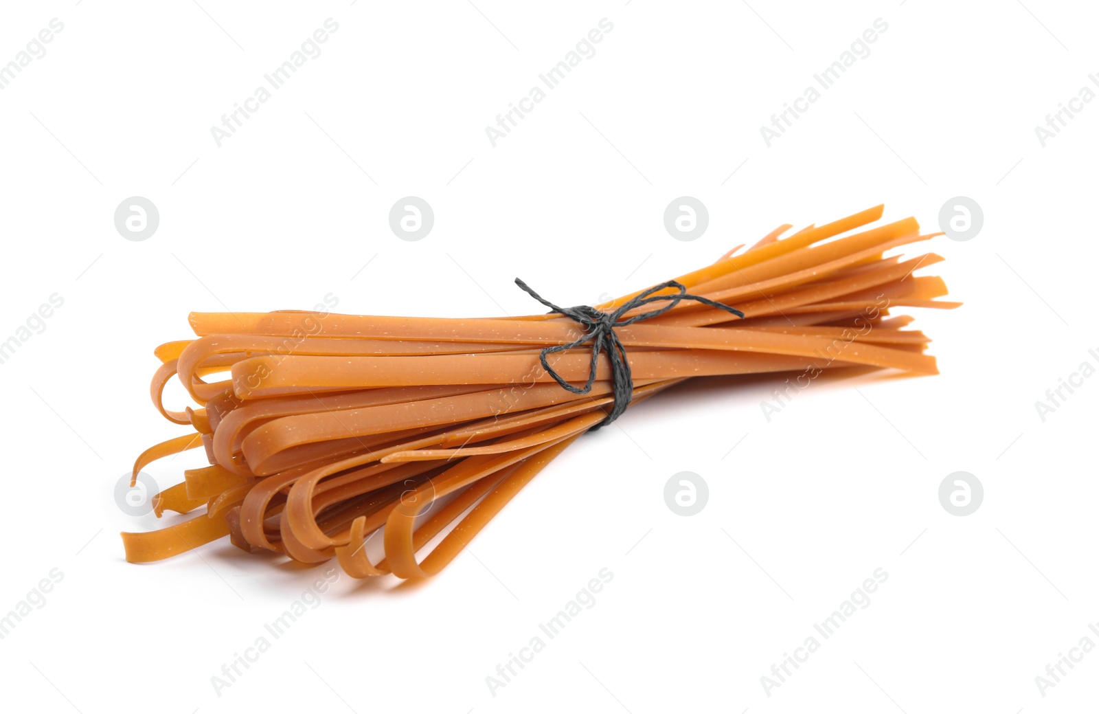 Photo of Tied uncooked buckwheat noodles isolated on white