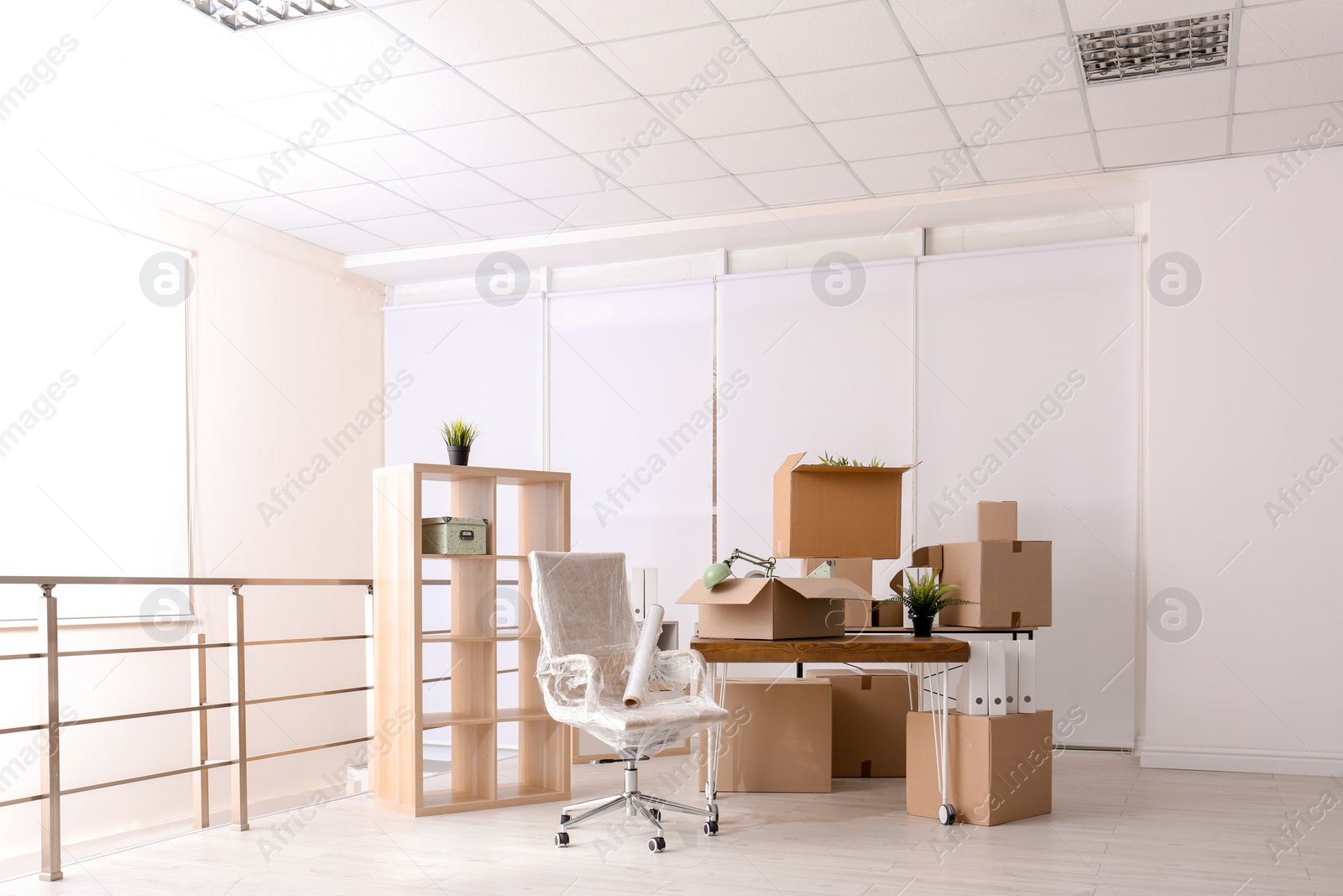 Photo of Carton boxes with stuff in room. Office move concept