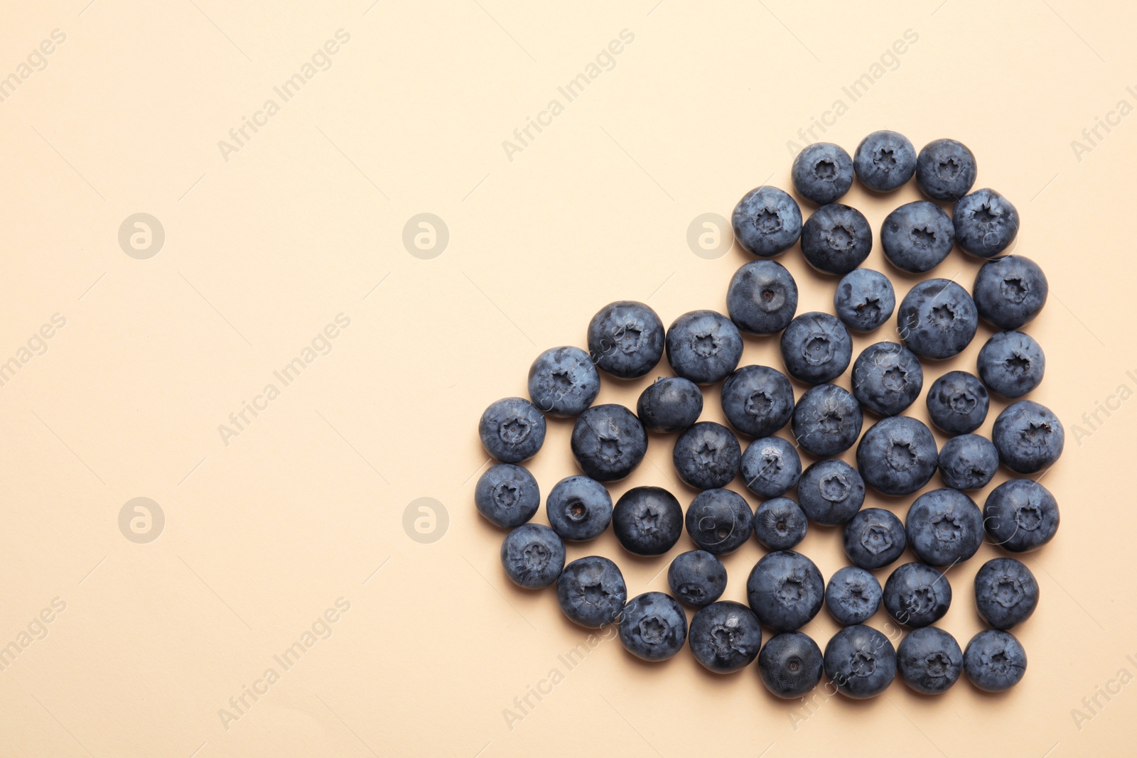 Photo of Flat lay composition with tasty blueberry and space for text on color background