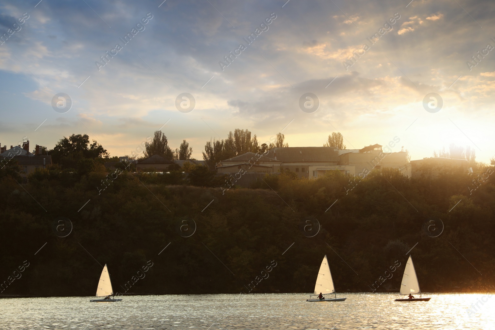 Photo of Picturesque view of river with sailboats and beautiful shore