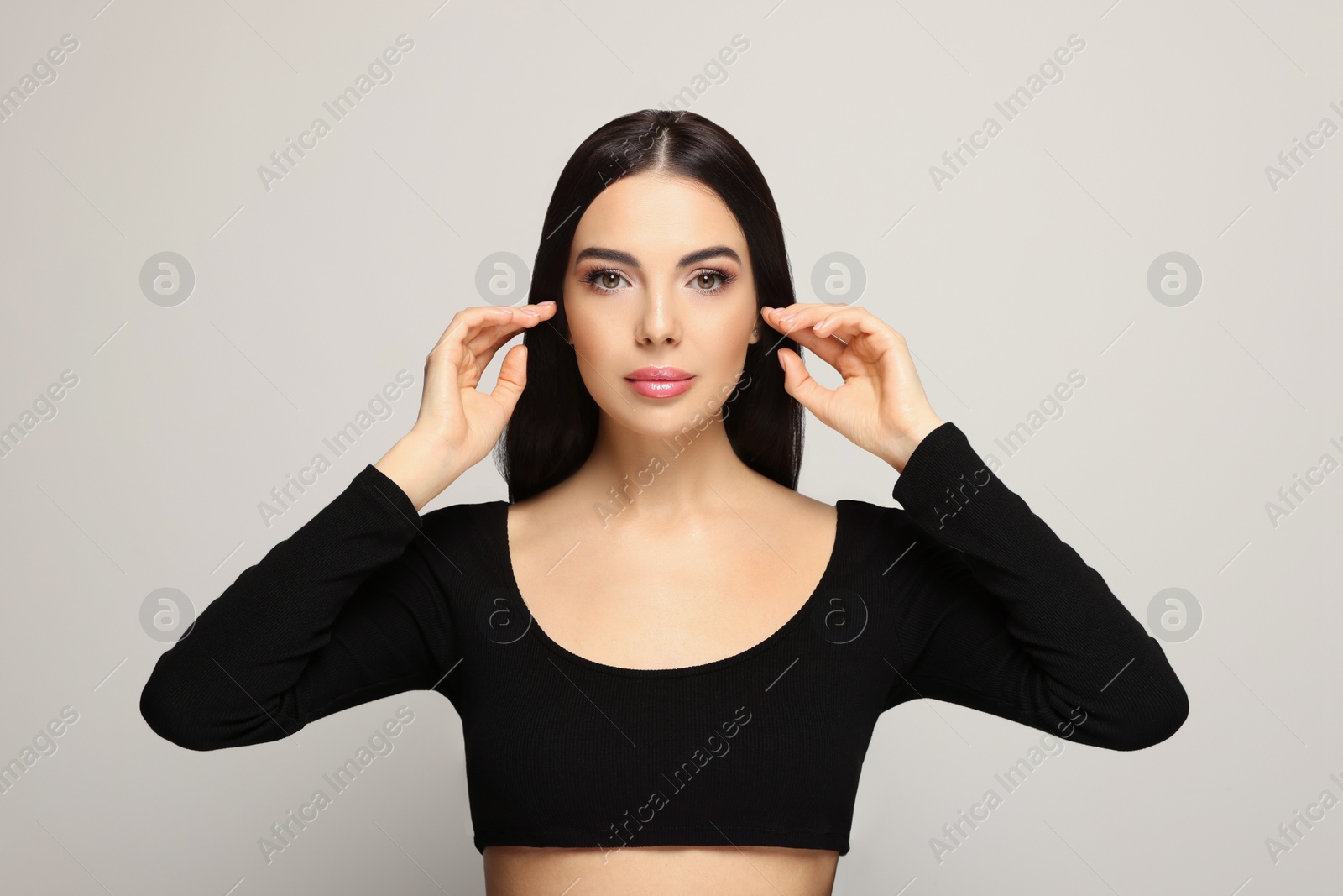 Photo of Portrait of beautiful young woman on light grey background