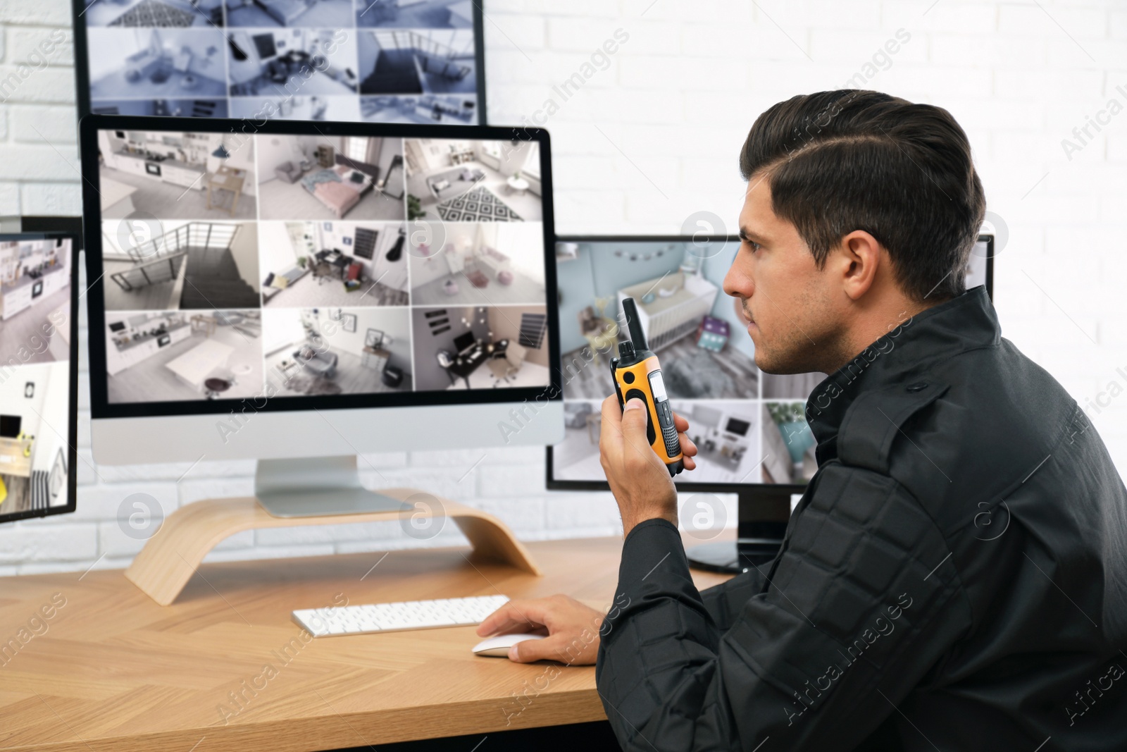 Photo of Male security guard with portable transmitter at workplace