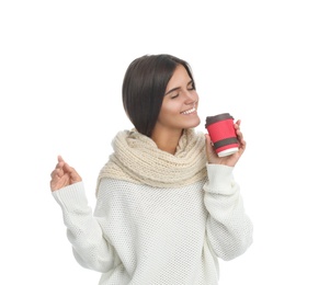 Happy beautiful woman with paper cup of mulled wine on white background