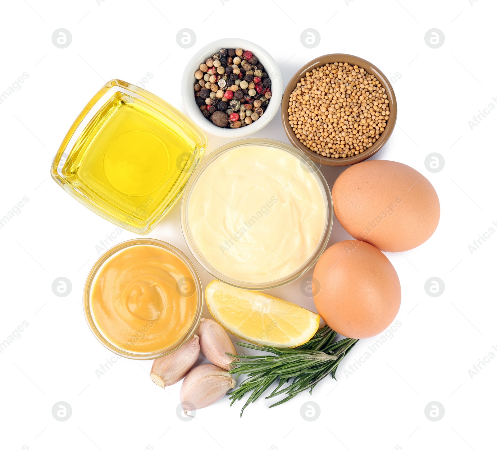 Photo of Glass bowl with fresh mayonnaise and ingredients on white background, top view