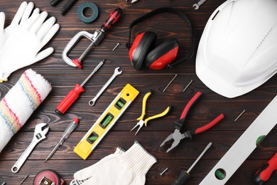 Photo of Flat lay composition with different construction tools on wooden background