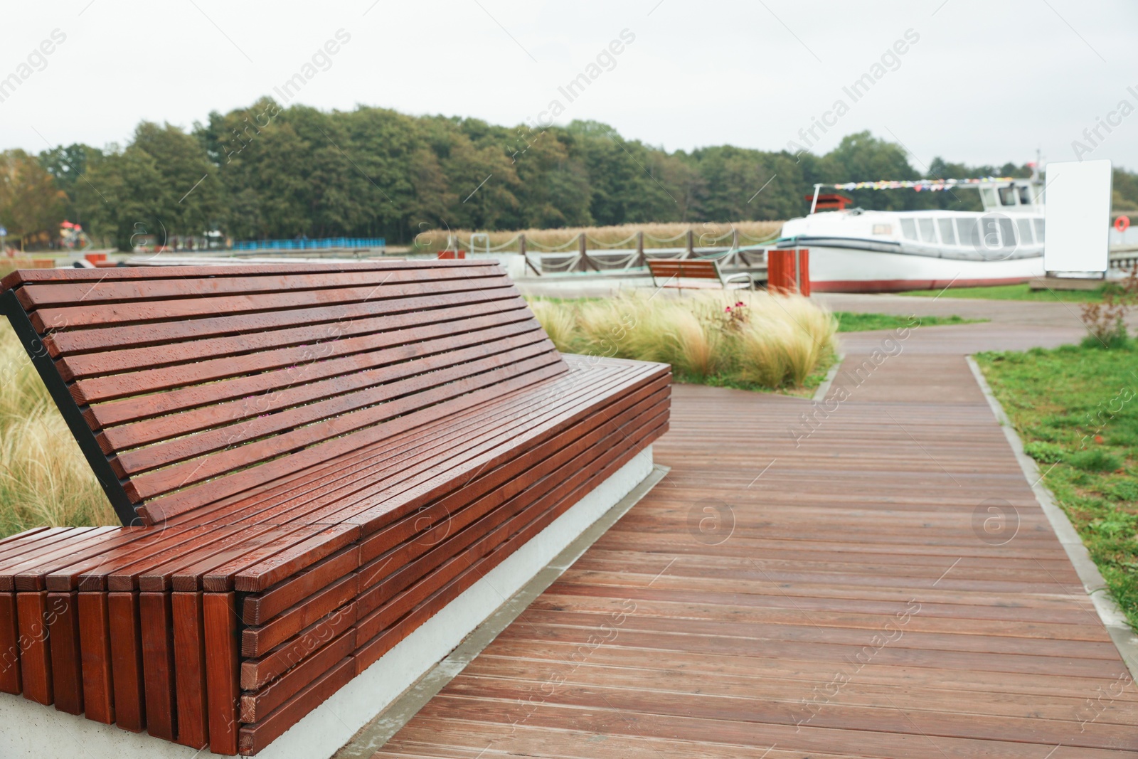 Photo of Recreation area with big wooden bench for rent outdoors. Real estate