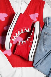 Pair of stylish red sneakers and clothes, flat lay