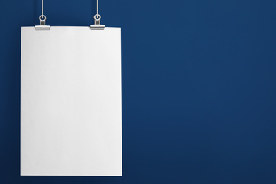 Image of Blank poster hanging near blue wall. Space for design